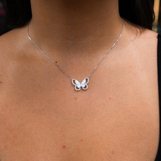 Butterfly necklace on a person's neck